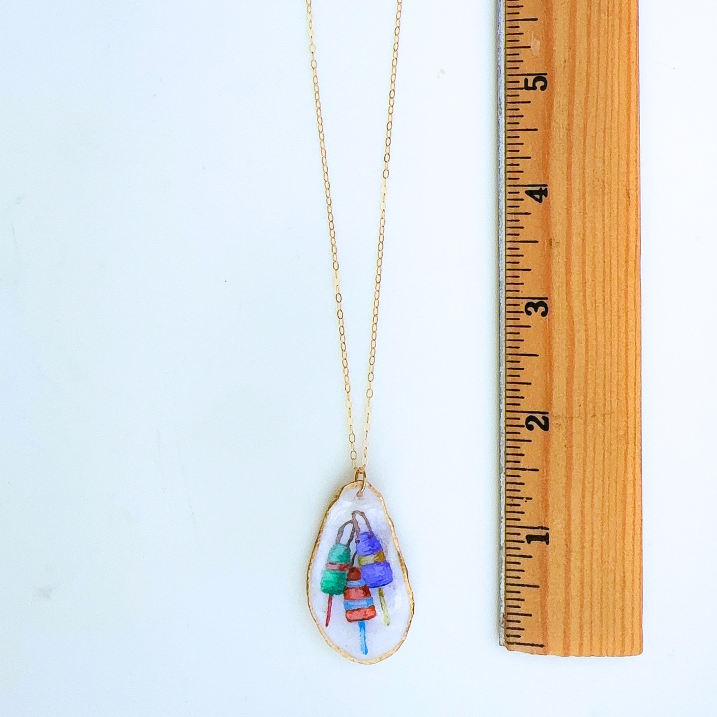 Buoy motif oyster shell necklace shown in gift-ready packaging