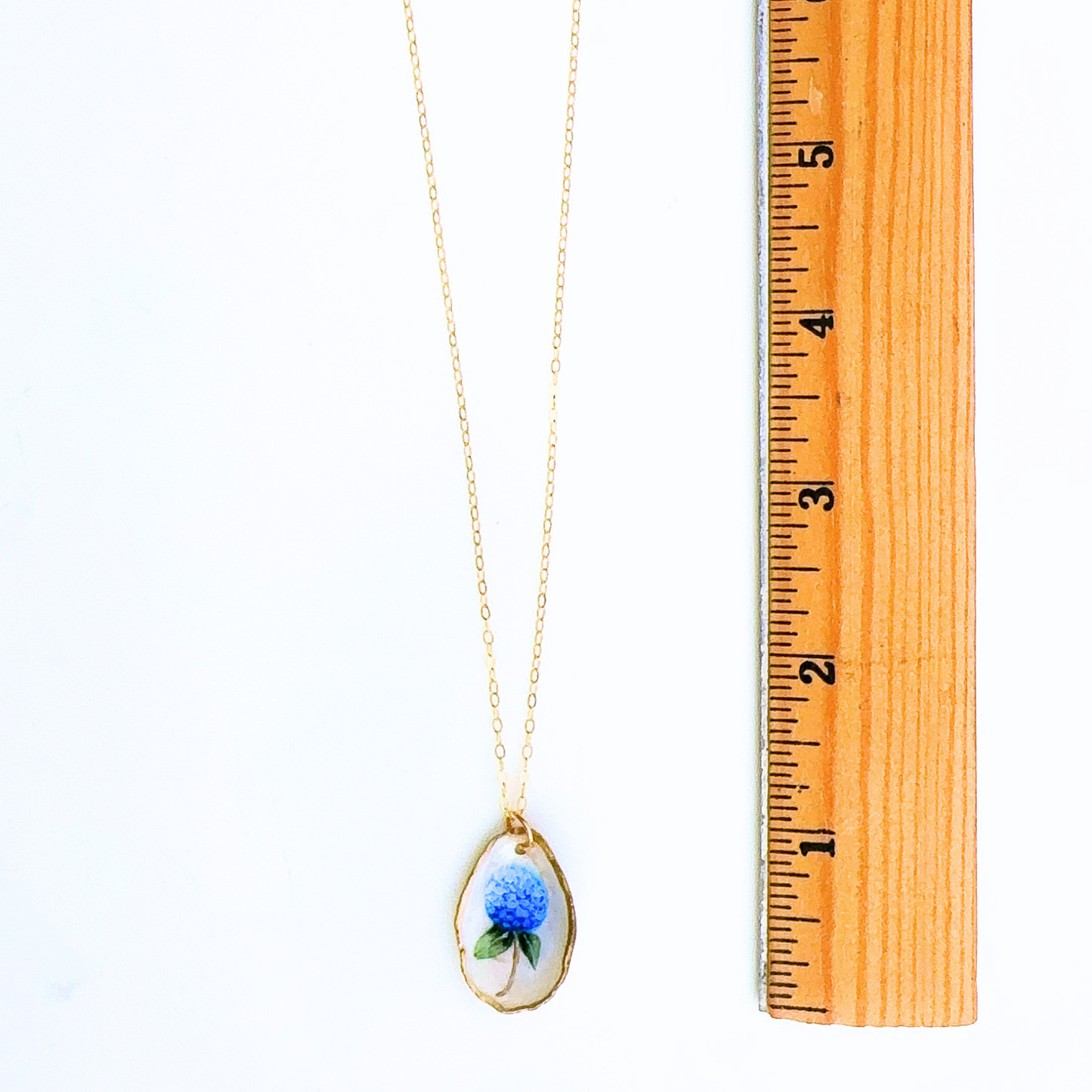 Hydrangea motif oyster shell necklace styled on a model, worn at the neckline