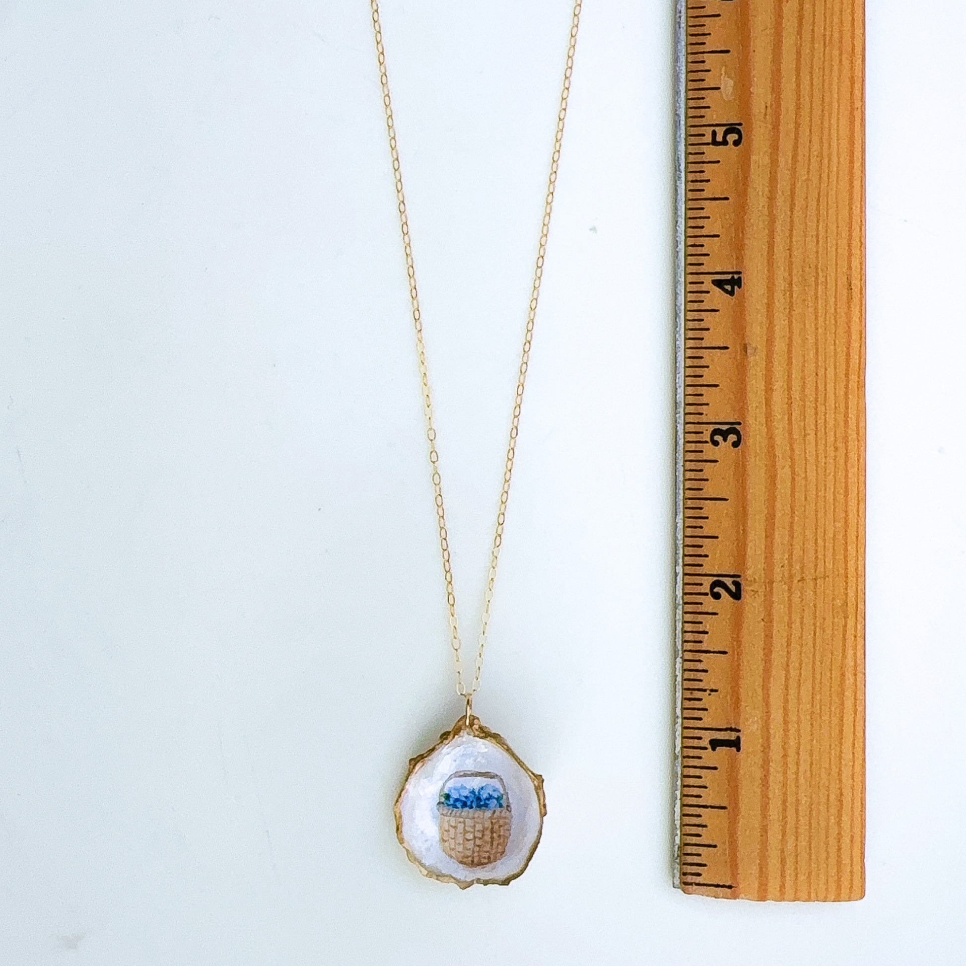 Nantucket basket motif oyster shell necklace shown in gift-ready packaging