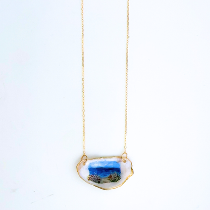 One-of-a-kind beach roses oyster shell necklace styled on a neutral background
