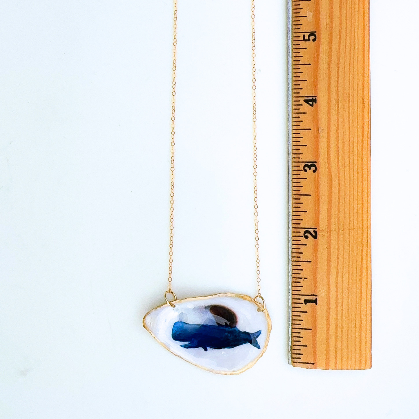 Whale motif oyster shell necklace shown in gift-ready packaging