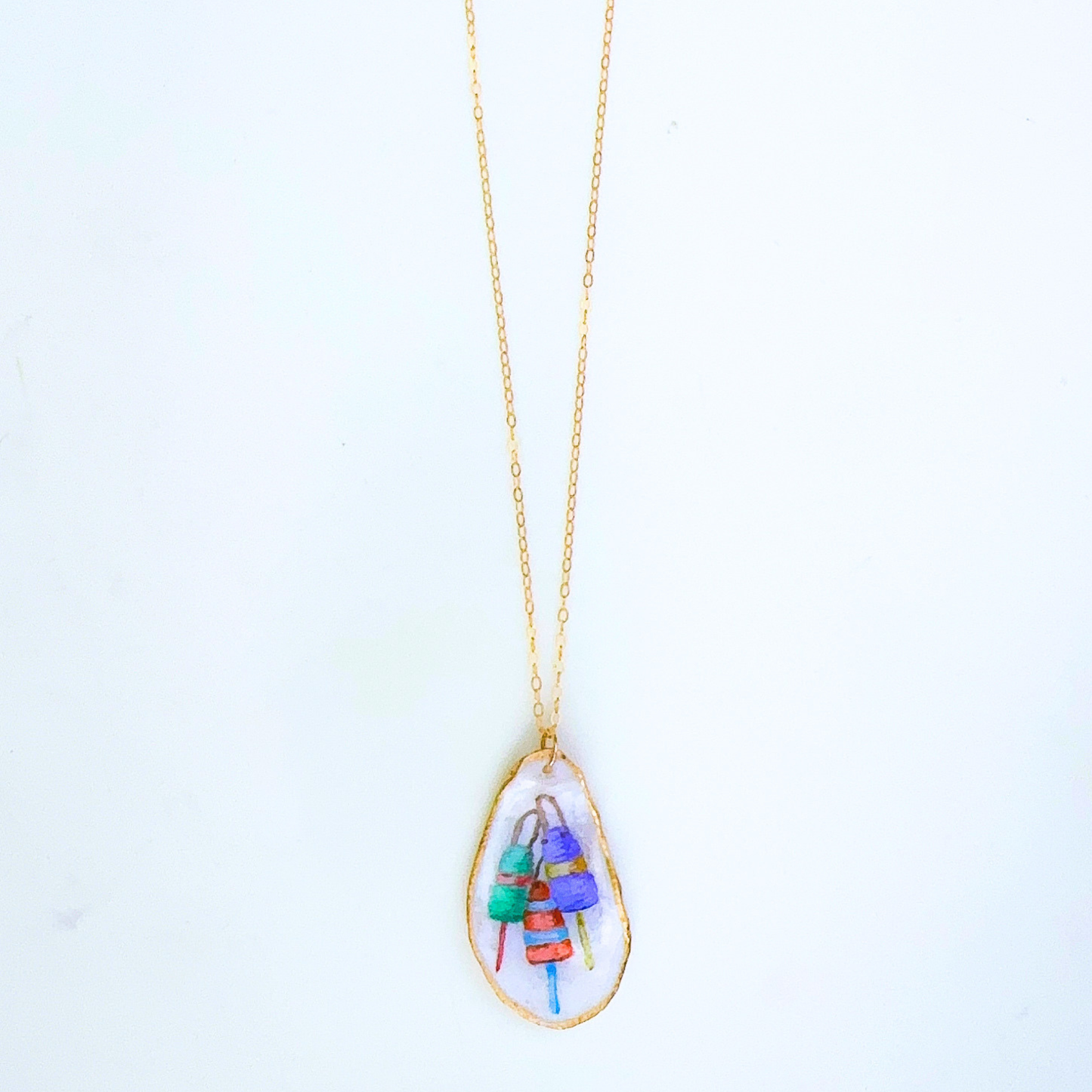 One-of-a-kind buoy oyster shell necklace styled on a neutral background