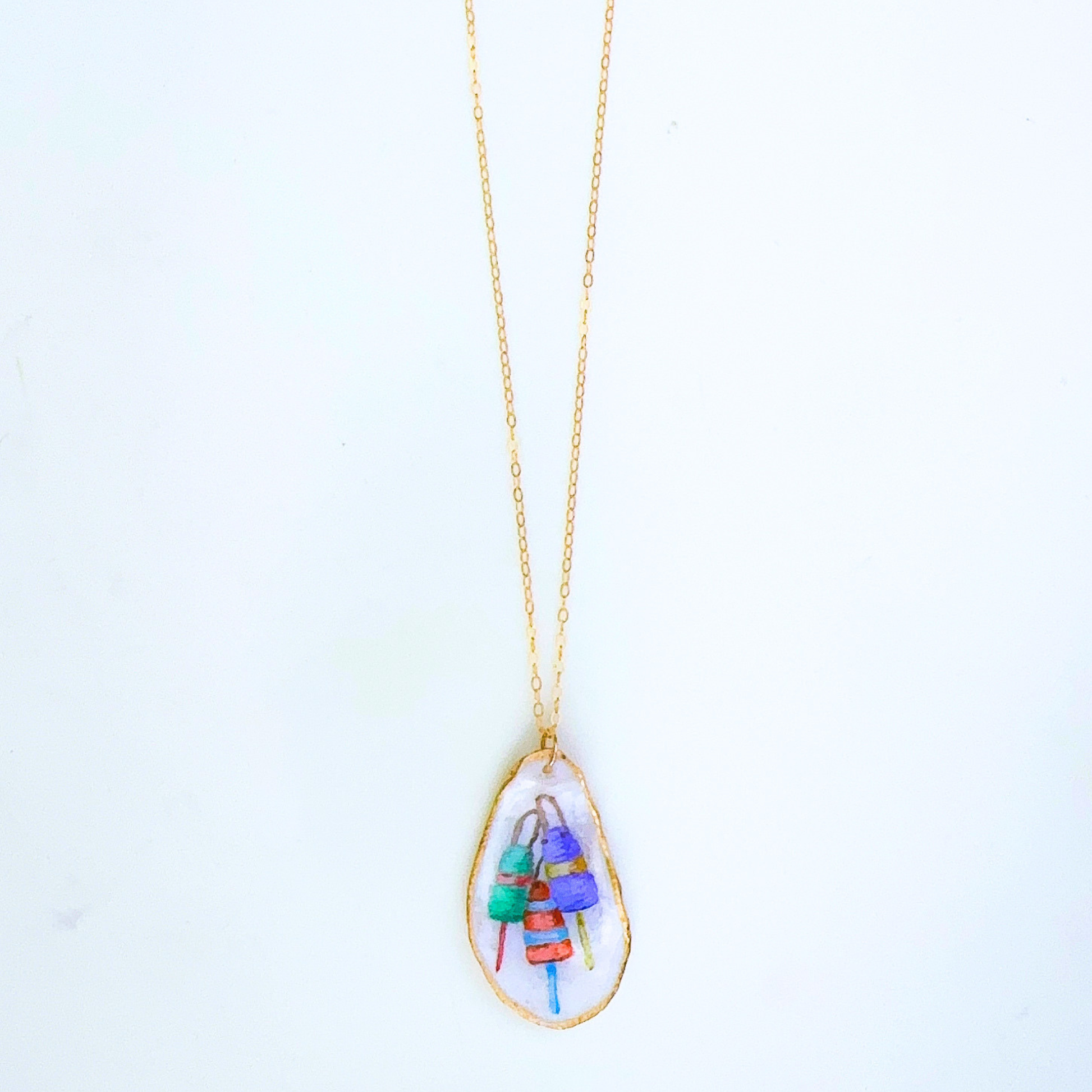 One-of-a-kind buoy oyster shell necklace styled on a neutral background