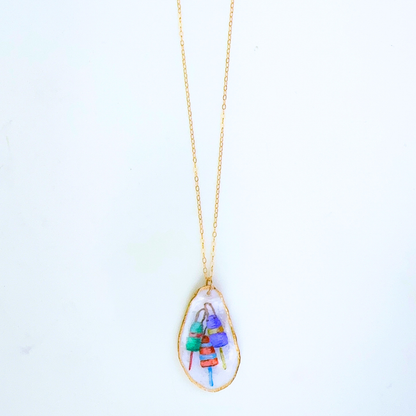 One-of-a-kind buoy oyster shell necklace styled on a neutral background