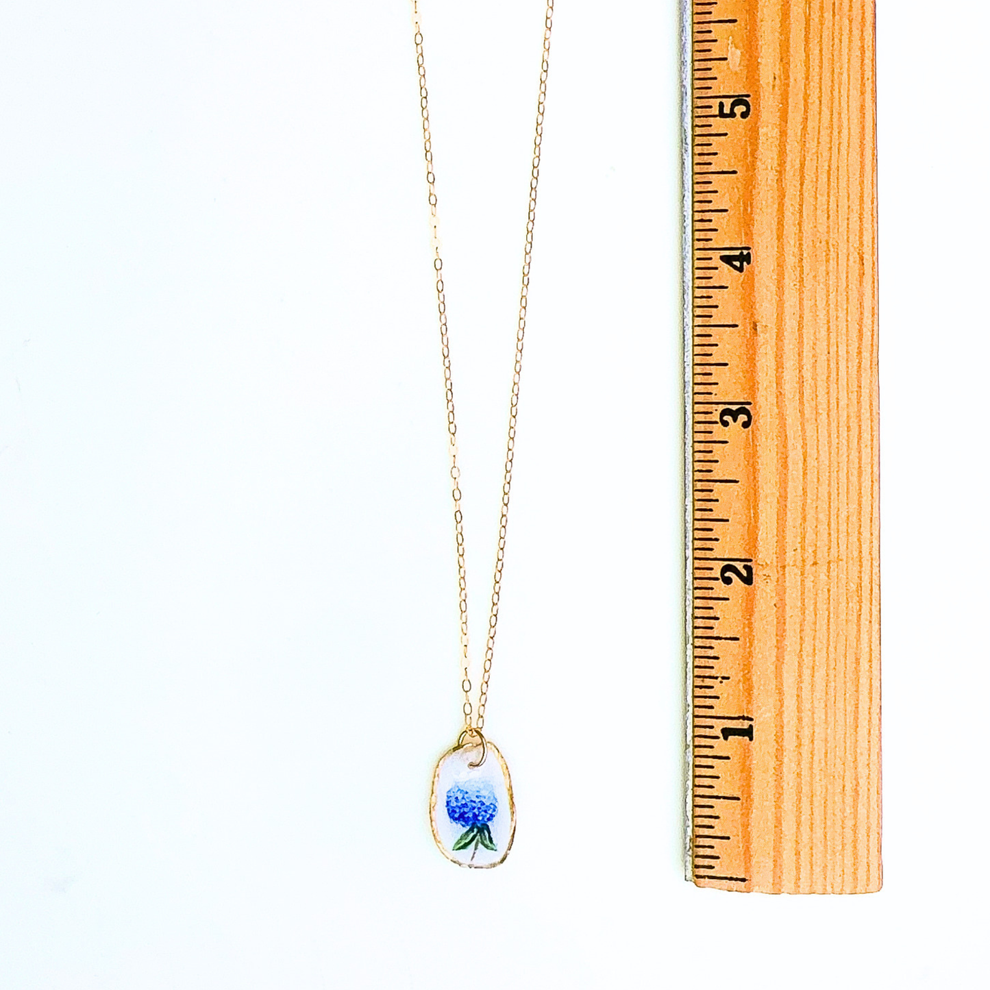 Oyster shell necklace with hydrangea motif shown in gift-ready packaging