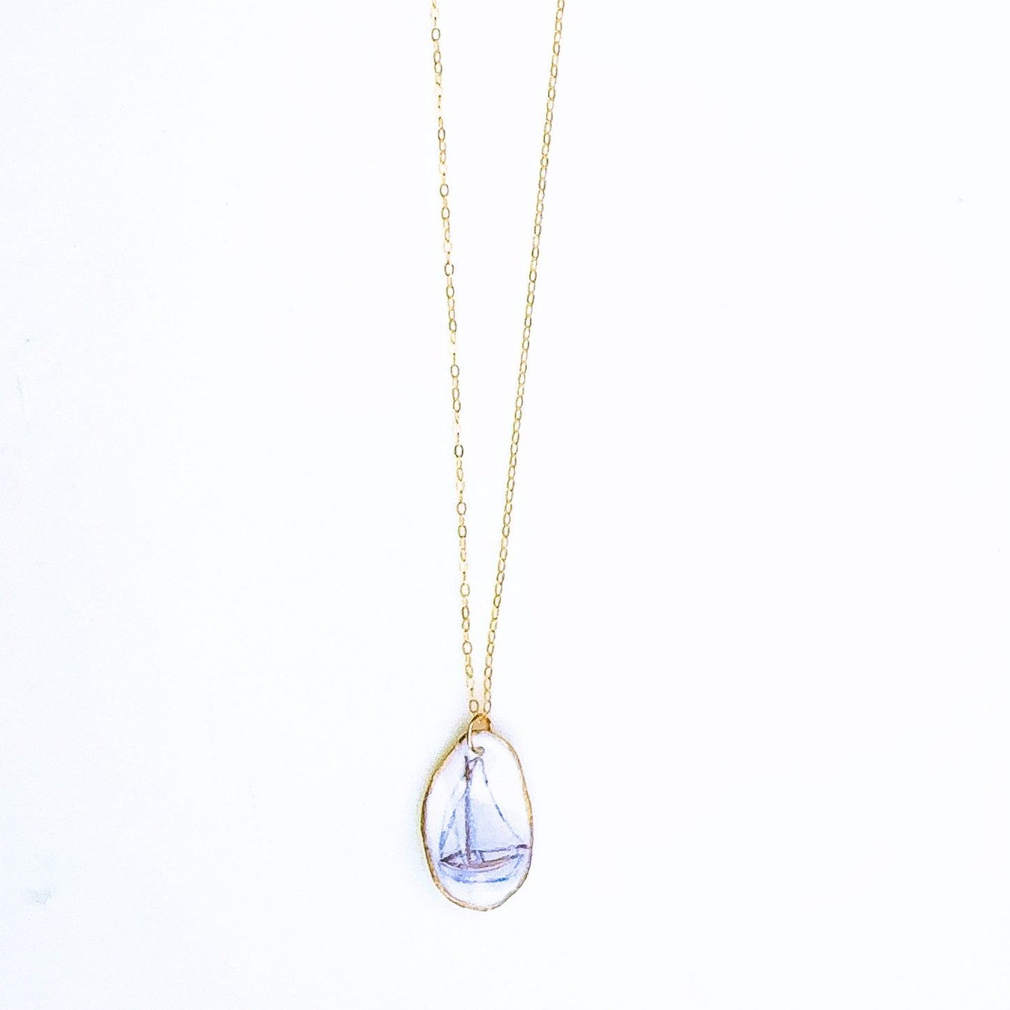 One-of-a-kind sailboat oyster shell necklace styled on a neutral background