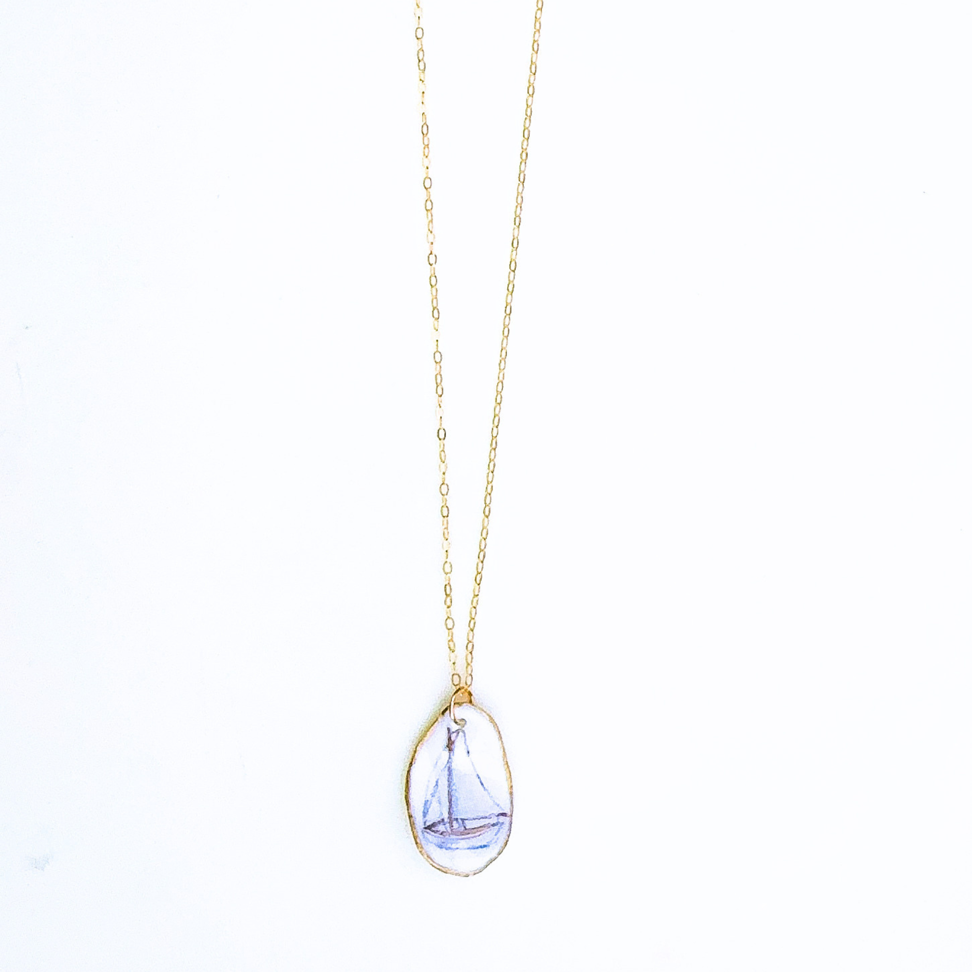 One-of-a-kind sailboat oyster shell necklace styled on a neutral background