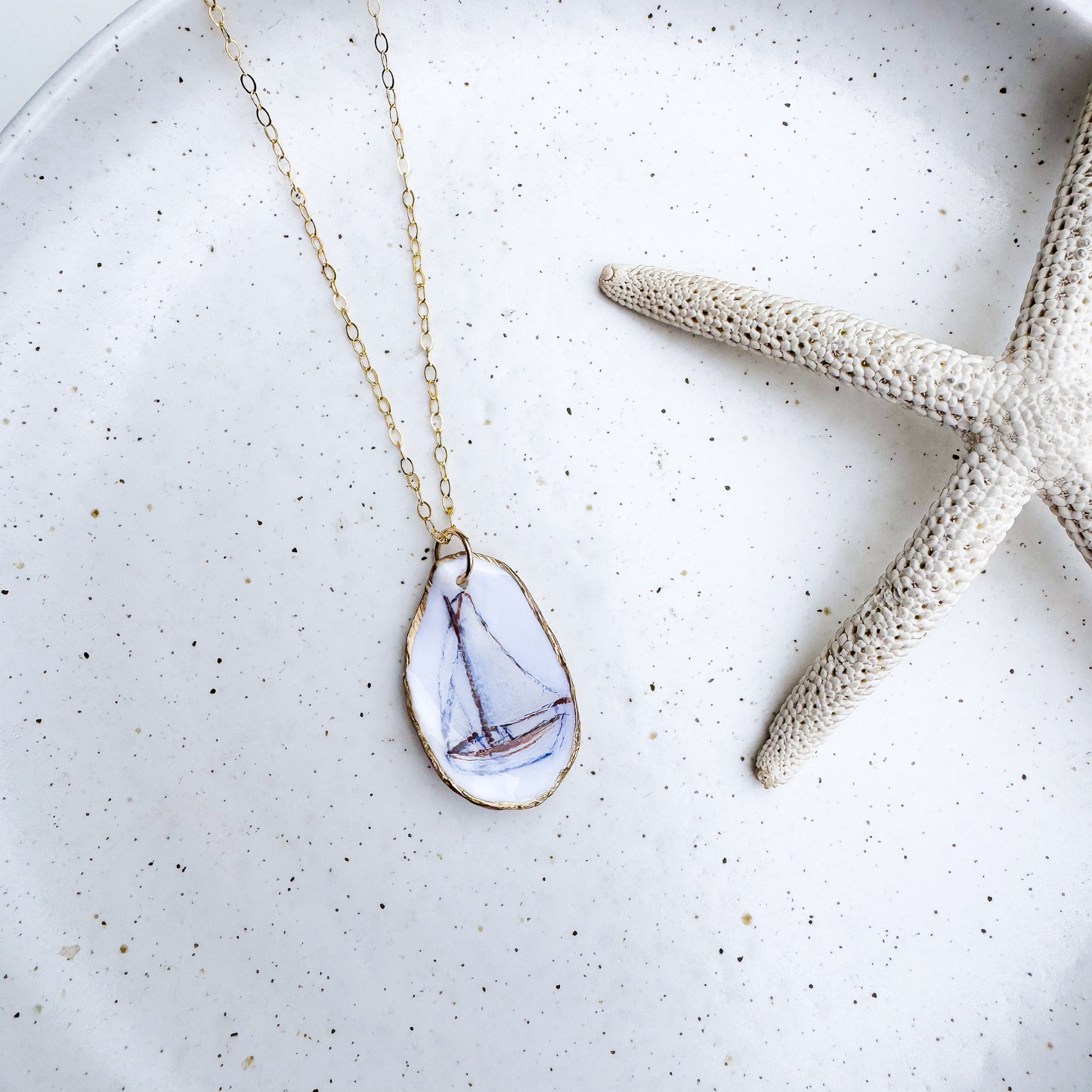 Hand-painted sailboat motif oyster shell necklace with gold-filled chain by Northern Tides Studio