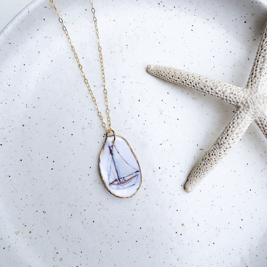 Hand-painted sailboat motif oyster shell necklace with gold-filled chain by Northern Tides Studio
